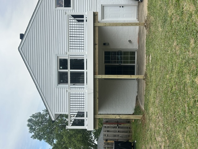 Finished second-story deck with white railings and black balusters